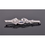 A 14ct white gold, diamond and sapphire bar brooch in the form of a bar with scrolled decoration,