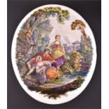 A large hand-painted KPM porcelain plaque of oval form, depicting a rural scene of a young man and