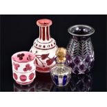 A collection of four cased glass vases comprising a silver overlaid purple glass vase, a Bohemian