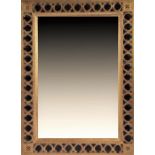 A large gilt framed decorative wall mirror  with looped decoration and bevelled plate glass, 116 x