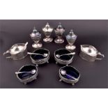 A George V silver cruet set  London 1935 - 1940, by William Comyns & Sons Ltd, comprising: four salt