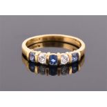 An 18ct yellow gold, diamond and sapphire ring bar set with two round cut diamonds of