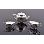 A novelty miniature silver tea set comprising of tea pot, milk jug, and sugar bowl, of semi-fluted