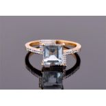 A 9ct yellow gold, diamond and aquamarine ring of asymmetric style, centred with a square cut