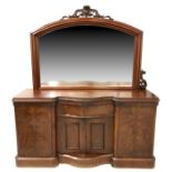 A Victorian mahogany mirror backed sideboard the mirrored back with scroll carved finial and