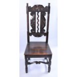 A mid-late 18th century high-back oak chair  with turned supports, united by scrolling and block