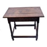 An 18th century oak side table  the rectangular plank top and single frieze drawer with incised