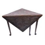 An 18th century carved oak gate-leg table  the heavily incised square top carved with symmetrical