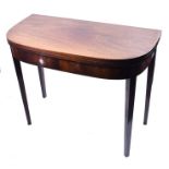 A George III mahogany folding card table  of square form with rounded corners, well matched