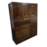 A large Heal & Son HealUnit mahogany compactum wardrobe   the top with blind fret decoration, over a