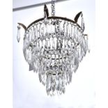 A 20th century three-tier bag light with prism cut glass drops, the frame with acanthus decoration.