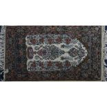 A small Eastern fringed wool rug  tokhe ivory ground interspersed with a symmetrical floral