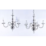 A matched set of four contemporary brushed chrome three-branch chandeliers   each with scrolling