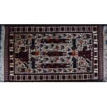 Two similar Turkish tribal fringed wool rugs  each with geometric figural detail upon ivory