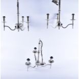 A set of four matching contemporary chromium plated three-branch chandeliers   each with swept arms,