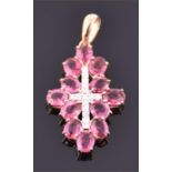 A 9ct yellow gold, diamond, and pink rubellite cross pendant set with a cross of round cut