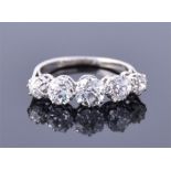 An impressive platinum and five stone diamond ring set with five graduated round cut stones of