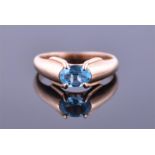 A 14ct yellow gold and blue topaz ring set with an oval cut stone, stamped Koby to shank, size N