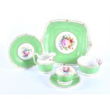 A large Royal Crown Derby hand painted tea set painted with flowers by F. Garnett, surrounded by