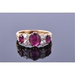 A Victorian 18ct yellow gold, diamond, and ruby ring set with an oval cut central ruby of