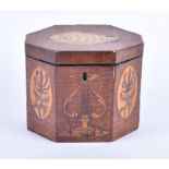A small Regency tea caddy of octagonal form. Decorated with satinwood inlay. The top panel detailing