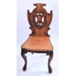 A Victorian mahogany hall chair  with carved and pierced shield-shaped back, solid seat and