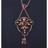 An Edwardian 9ct yellow gold, garnet, and split seed pearl pendant set with three sunset garnets and