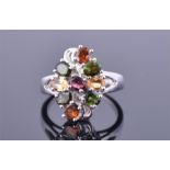 A silver and tourmaline cluster ring set with oval cut orange, yellow, green, and pink tourmalines