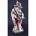 A large Austrian ceramic figure of a young boy a young travelling musician with instrument. Brightly