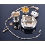 A small collection of silver items including a wine taster, two egg cups, a curblink chain, an