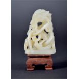 A late 18th / early 19th century Chinese carved white jade study of a dragon. set within a scrolling