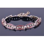 A silver and guilloche enamel bracelet by Marius Hammer having red enamelled openwork segments,