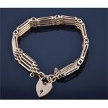 A 9ct gold gate-link bracelet, polished and textured links, heart-shaped padlock clasp, 26 grams.