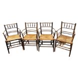 A set of four similar Morris & Co Century spindle back oak elbow chairs each with rush seats