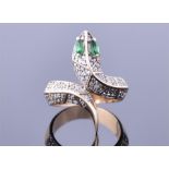 A 14ct yellow gold, diamond, and emerald snake ring pavé set with diamonds, and with two marquise