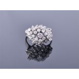 A diamond cluster ring, centred with a round brilliant-cut diamond weighing approximately 0.17cts,