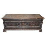 A late 17th / early 18th century carved oak chest the top carved with three panels of stylised