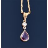 An 18ct yellow gold, ruby, and diamond pendant set with a pear cut natural ruby of approximately 0.