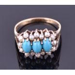 A 9ct yellow gold, turquoise and pearl ring  set with three oval cut turquoise stones, surrounded by