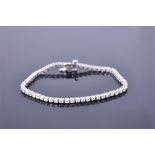 A 14ct white gold and diamond tennis bracelet set with round brilliant cut diamonds of approximately
