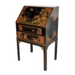 A Waring & Gillow black lacquered chinoiserie bureau the fall front decorated with birds and figures