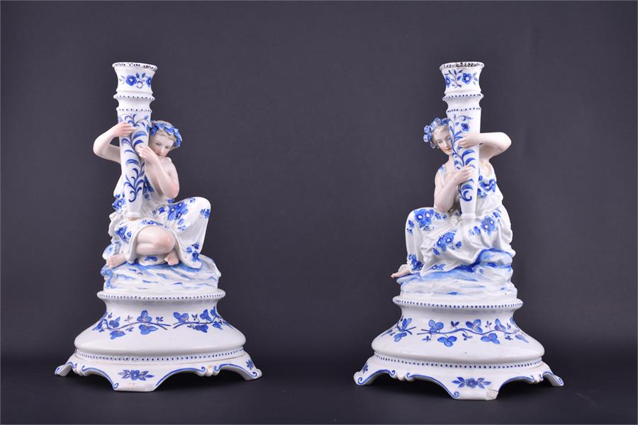 A pair of late 19th century Continental porcelain figural candlesticks formed as young ladies