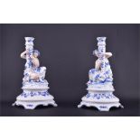 A pair of late 19th century Continental porcelain figural candlesticks formed as young ladies