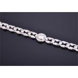 An impressive Art Deco platinum and diamond bracelet centered with a round brilliant cut diamond