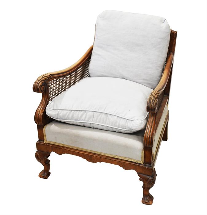 A late 19th Century continental  bergere chair scrolling acanthus arms with carved cabriole