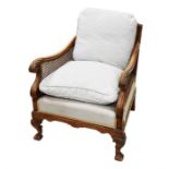 A late 19th Century continental  bergere chair scrolling acanthus arms with carved cabriole