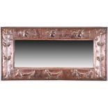 An early 20th Century wall mirror in the Arts & Crafts style of rectangular form, the copper clad