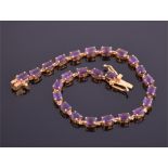 A silver gilt and amethyst bracelet set with twenty five oval cut amethsyts, length 21cm