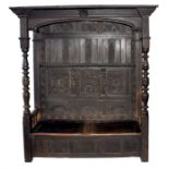 A large 17th/18th century and later oak canopy settle the back with deep carved panels depicting