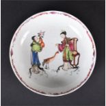 An 18th century shallow porcelain bowl, probably Worcester painted with two oriental figures, each